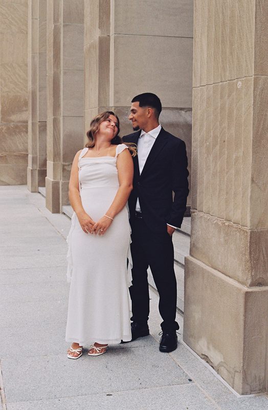 Juan David smiling at Hannah as they stand among stone columns