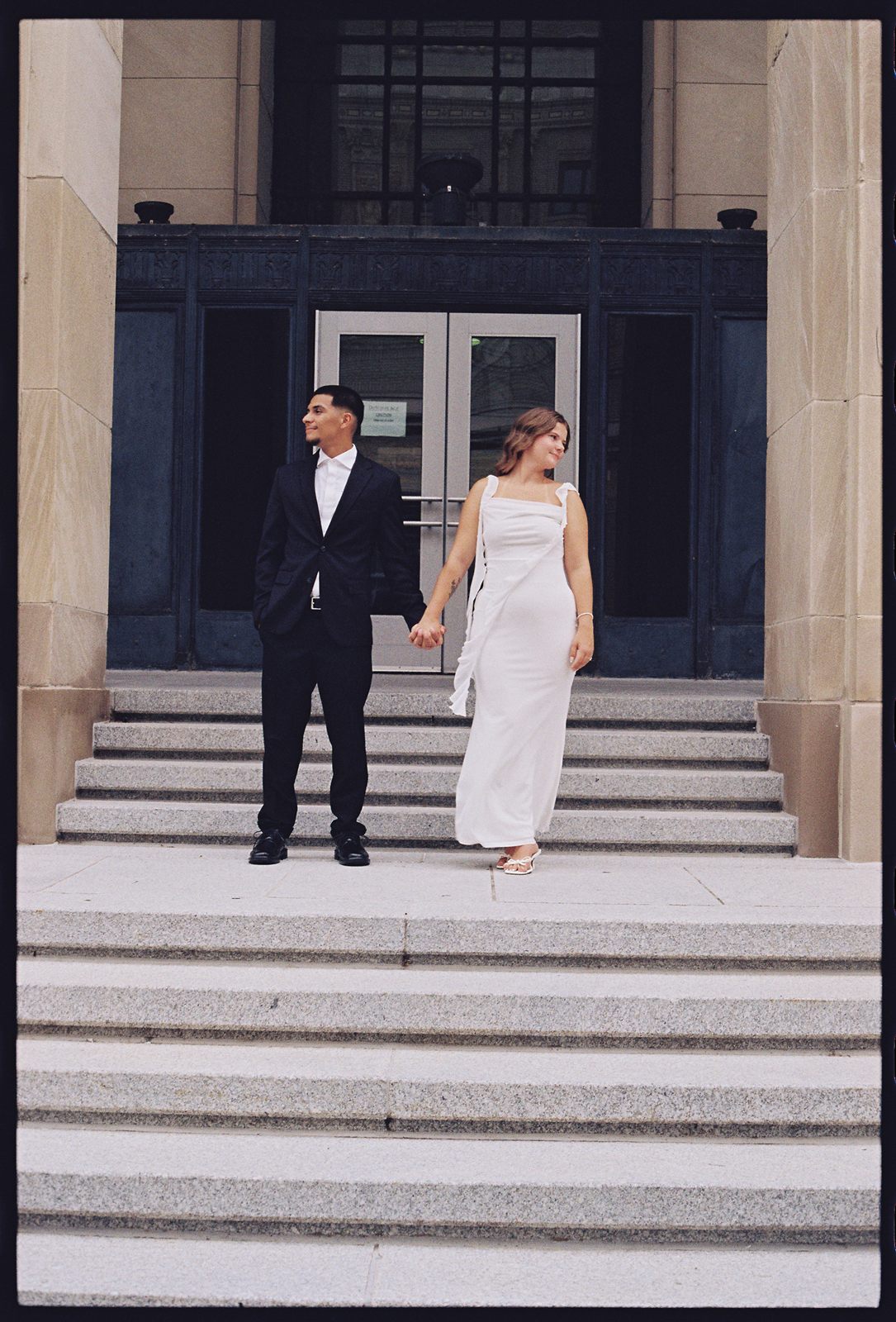 Juan David and Hannah holding hands at the top of wide stone steps